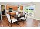 Open dining area next to the kitchen features a dark wooden table, chairs, and backyard access at 5456 Reston Dr, Plainfield, IN 46168