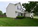 Side view of a two-story home with vinyl siding, a well-kept lawn, and landscaping at 5456 Reston Dr, Plainfield, IN 46168