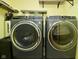 Laundry room features front loading washer and dryer, with extra shelving for storage at 5456 Reston Dr, Plainfield, IN 46168
