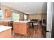 Open concept kitchen and living area with stainless steel appliances, dining table, and vinyl floors at 5456 Reston Dr, Plainfield, IN 46168