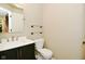This half-bathroom offers a sleek vanity with a white countertop and a comfort height toilet with glass shelves above at 5456 Reston Dr, Plainfield, IN 46168