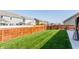 The backyard features lush grass, a privacy fence, and neighboring homes at 5794 Cherrywood Ln, McCordsville, IN 46055