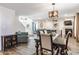 Open-concept dining area connected to the living room, featuring a stylish chandelier at 5794 Cherrywood Ln, McCordsville, IN 46055