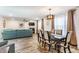 Bright dining area with a table for six, stylish lighting, and open access to the living room at 5794 Cherrywood Ln, McCordsville, IN 46055