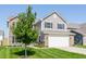 Two-story home with a two-car garage and well-manicured lawn, showcasing its inviting curb appeal at 5794 Cherrywood Ln, McCordsville, IN 46055