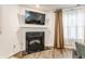 Close-up of fireplace with black granite hearth, white mantel, and decorative curtains at 5794 Cherrywood Ln, McCordsville, IN 46055