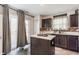 Well-lit kitchen featuring dark cabinets, mosaic backsplash, and stainless steel sink at 5794 Cherrywood Ln, McCordsville, IN 46055