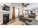 Cozy living room featuring a fireplace, a ceiling fan, and modern decor at 5794 Cherrywood Ln, McCordsville, IN 46055