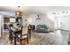 Open concept living room featuring hardwood floors, dining area, and comfortable seating at 5794 Cherrywood Ln, McCordsville, IN 46055