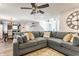 Spacious living room featuring a large sectional sofa, ceiling fan, and open layout at 5794 Cherrywood Ln, McCordsville, IN 46055