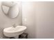 Simple powder room with a modern sink, oval mirror, and neutral walls at 5794 Cherrywood Ln, McCordsville, IN 46055