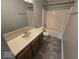 Cozy bathroom featuring a shower-tub combo, vanity with storage, and a tile floor at 5825 Sapelo Dr, Indianapolis, IN 46237