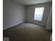 Neutral bedroom with soft carpet and plenty of natural light from the large window at 5825 Sapelo Dr, Indianapolis, IN 46237