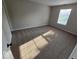 Bright bedroom with neutral walls, plush carpeting, and natural light from a large window at 5825 Sapelo Dr, Indianapolis, IN 46237