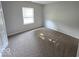 Neutral bedroom features a window and carpeted flooring at 5825 Sapelo Dr, Indianapolis, IN 46237