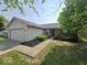 Charming single-story home with a well-maintained lawn, attached garage, and beautiful curb appeal at 5825 Sapelo Dr, Indianapolis, IN 46237