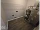 Utility room with washer/dryer hookups, water heater, and HVAC unit with laminate flooring at 5825 Sapelo Dr, Indianapolis, IN 46237