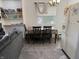 A well-lit dining area features a table for four next to the refrigerator and built in shelves at 5941 Deerwood Ct, Indianapolis, IN 46254