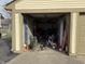 This garage is full of bicycles, chairs, and equipment at 5941 Deerwood Ct, Indianapolis, IN 46254