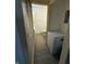 Hallway with freezer and an entryway to a half bath at 5941 Deerwood Ct, Indianapolis, IN 46254