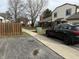 A street view captures a townhome with sidewalk and a glimpse of the surrounding neighborhood, plus the car parked next to the sidewalk at 5941 Deerwood Ct, Indianapolis, IN 46254