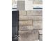 Sample of Carolina Ledgestone material with dark cabinetry and light grey wooden siding samples at 600 Bluestem Ln, New Whiteland, IN 46184