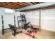 Unfinished basement with exercise equipment, exposed ceiling, and concrete floor at 6180 Winnpeny Ln, Indianapolis, IN 46220