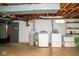 Basement laundry area with washer, dryer, water softener, and utility sink at 6180 Winnpeny Ln, Indianapolis, IN 46220