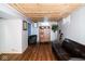 Finished basement with wood paneled ceiling, cabinets, seating, and windows at 6180 Winnpeny Ln, Indianapolis, IN 46220