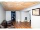 Spacious basement with wood ceiling, storage, seating, and picture on wall at 6180 Winnpeny Ln, Indianapolis, IN 46220