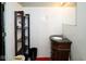 Classic bathroom featuring a vintage vanity with a black countertop, an adjacent black shelf, and tiled walls at 6180 Winnpeny Ln, Indianapolis, IN 46220