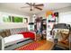 Bedroom features a cozy daybed, a closet filled with clothes, and a treadmill for a convenient workout space at 6180 Winnpeny Ln, Indianapolis, IN 46220