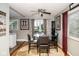Cozy dining area with a round glass table, seating for four, and a ceiling fan at 6180 Winnpeny Ln, Indianapolis, IN 46220