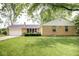 Charming single story home featuring an attached garage and well-maintained lawn at 6180 Winnpeny Ln, Indianapolis, IN 46220