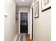 Hallway featuring black doors and hardwood floors, enhanced by framed artwork along the light-colored walls at 6180 Winnpeny Ln, Indianapolis, IN 46220