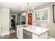 Kitchen island featuring white cabinets, granite countertops, stainless steel appliances, and modern lighting at 6180 Winnpeny Ln, Indianapolis, IN 46220