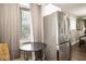 Kitchen nook area featuring stainless steel refrigerator, table, and window at 6180 Winnpeny Ln, Indianapolis, IN 46220