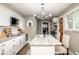 Bright kitchen featuring white cabinets, granite countertops, stainless steel appliances, and hardwood floors at 6180 Winnpeny Ln, Indianapolis, IN 46220