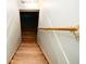 Staircase with wooden steps and handrail descending into basement at 6180 Winnpeny Ln, Indianapolis, IN 46220