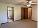Large bedroom with ceiling fan, closet, and attached bathroom at 641 S Grant St, Brownsburg, IN 46112