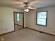 Bright bedroom with ceiling fan, window, and mirrored closet doors at 641 S Grant St, Brownsburg, IN 46112