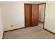 Bedroom features neutral carpet, closet, and views into another room at 641 S Grant St, Brownsburg, IN 46112