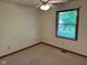 Cozy bedroom with neutral carpet, ceiling fan, and window providing ample natural light at 641 S Grant St, Brownsburg, IN 46112