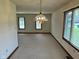 Spacious dining room with neutral carpet, ample natural light and classic chandelier lighting at 641 S Grant St, Brownsburg, IN 46112