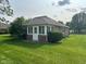 Enclosed patio with brick construction, screened windows, and a door leading to the yard at 641 S Grant St, Brownsburg, IN 46112