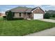 Charming brick home featuring an attached garage, manicured lawn, and beautiful landscaping at 641 S Grant St, Brownsburg, IN 46112