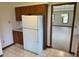 Kitchen with white refrigerator and doorway to carpeted living area at 641 S Grant St, Brownsburg, IN 46112