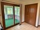 Living room entrance featuring sunroom access, closet and vinyl flooring at 641 S Grant St, Brownsburg, IN 46112