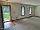 Bright living room featuring neutral carpet, front door entrance, and views to the outside at 641 S Grant St, Brownsburg, IN 46112