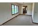 Bright living room with neutral carpet, large window, and view to the next room at 641 S Grant St, Brownsburg, IN 46112